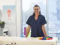 Une kinésithérapeute souriante dans sa salle de soins, prête à accueillir ses patients. L'école kine Saragosse forme des professionnels de santé.