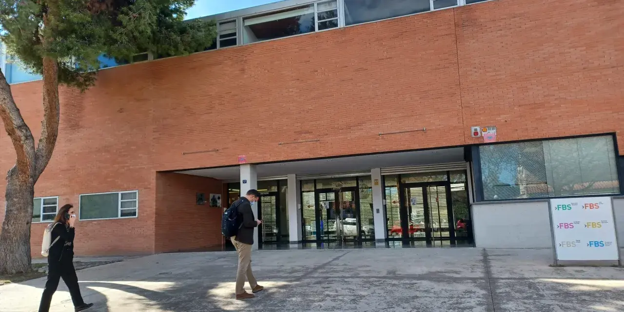Étudiants se promenant devant le bâtiment de la faculté de sciences économiques de l'université d'Alicante.