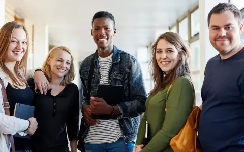 Groupe d'étudiants souriants, prêts à devenir des experts en marketing à distance.