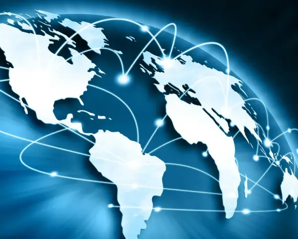 Carte du monde bleue avec des lignes lumineuses connectant les continents, symbolisant le commerce international et un futur doctorat.