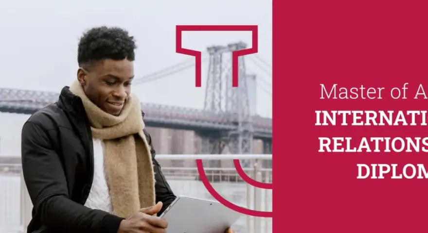Un jeune homme étudie sur sa tablette, prêt à commencer son master relations internationales à distance.
